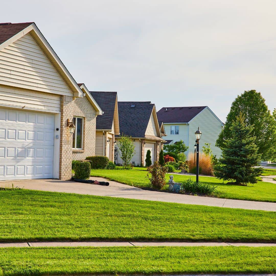 Row of suburban houses with green grass lawns, a reminder of how long do home inspections take for typical single-family homes